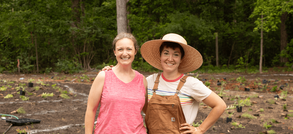 Women posing in a vegetable garden